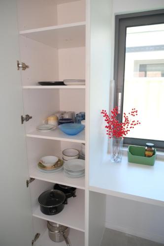 a white pantry with dishes and a window at A2-Family friendly 2B1BHouse nr airport backyard&carparking in Perth