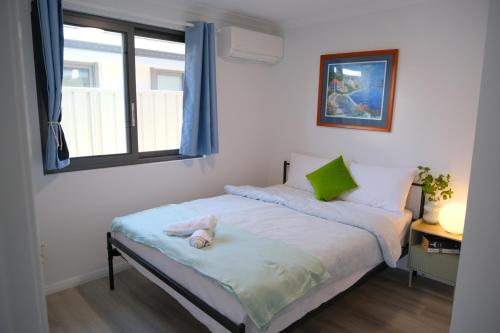 a bedroom with a bed with a stuffed animal on it at A2-Family friendly 2B1BHouse nr airport backyard&carparking in Perth