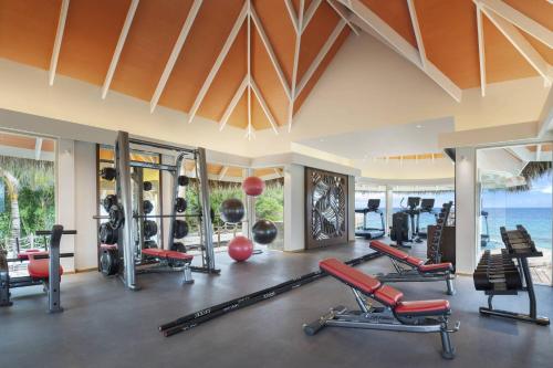 a gym with exercise equipment in a resort at JW Marriott Maldives Resort & Spa in Funadhoo