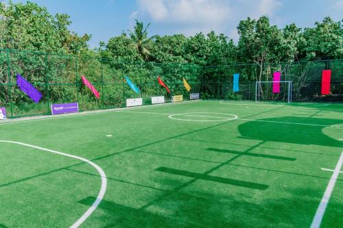 a green tennis court with colorful flags on it at JW Marriott Maldives Resort & Spa in Funadhoo