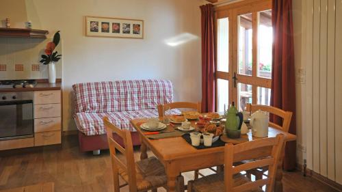 a kitchen with a table and chairs with a table and a table at La Nicchia in Tarzo