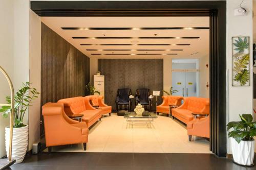 an office lobby with orange chairs and a waiting room at Eighty Eight Hotel in Koronadal