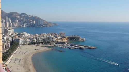 an aerial view of a beach with boats in the water at Apartamentos Beni-Beach in Benidorm