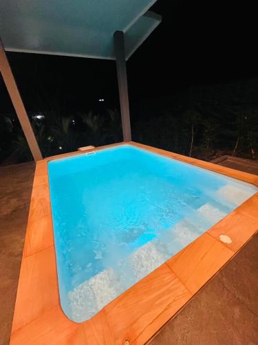 a blue swimming pool on a deck at night at Hornbill Pool Villas 1 in Ko Chang