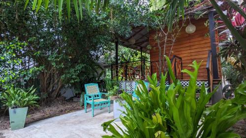 a blue chair sitting in front of a house at Soul Villas & Cabana Near Beach with Pool in Tangalle
