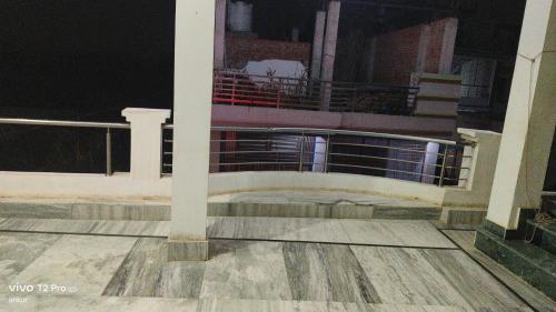 a balcony of a house at night with a fence at Pooja homestay in Prayagraj