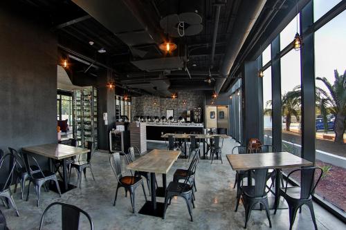 a restaurant with wooden tables and chairs and windows at Aloft Ponce Hotel & Casino in Ponce
