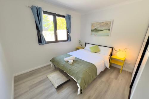 a bedroom with a bed and a window at B3 Near Airport - Cozy Home, Walk to Shops & Eats in Perth