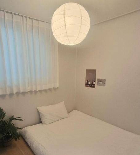 a room with a bed and a large light fixture at Dal126 House Seoul in Seoul