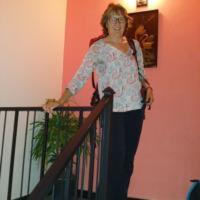 a woman is standing next to a railing at Villa Paragon in Negombo