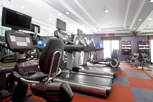 a gym with several tread machines in a room at Courtyard by Marriott Port of Spain in Port-of-Spain
