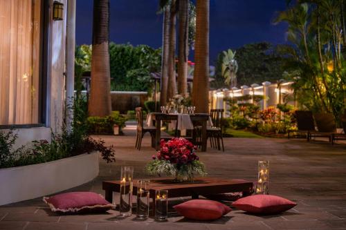 a patio with a table and chairs and lights at Courtyard by Marriott Port of Spain in Port-of-Spain