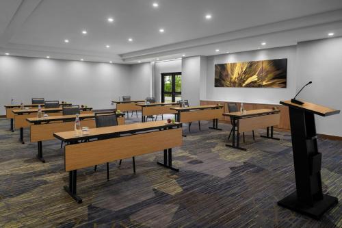 a classroom with desks and a podium in a room at Courtyard by Marriott Port of Spain in Port-of-Spain