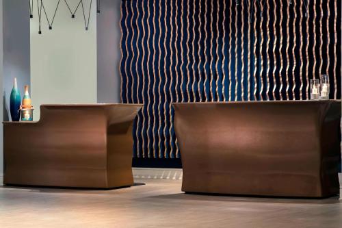 a room with two brown tables and a striped wall at Renaissance Fort Lauderdale Cruise Port Hotel in Fort Lauderdale
