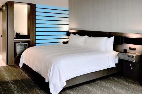 a large white bed in a hotel room at Renaissance Reno Downtown Hotel & Spa in Reno