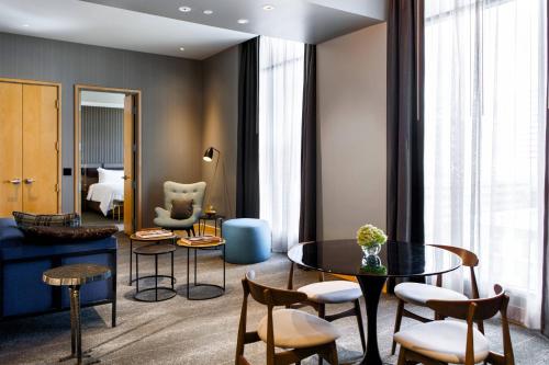 a living room with a table and chairs at Renaissance Reno Downtown Hotel & Spa in Reno