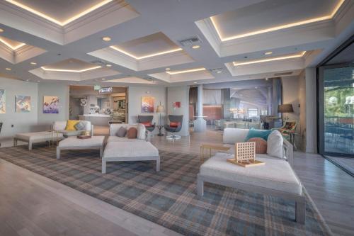 a living room with couches and tables in a room at Renaissance Reno Downtown Hotel & Spa in Reno
