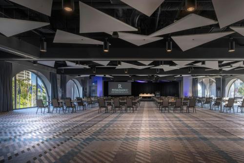 a large room with chairs and a projection screen at Renaissance Reno Downtown Hotel & Spa in Reno