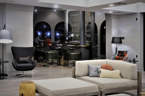 a living room with a couch and a bar at Renaissance Reno Downtown Hotel & Spa in Reno
