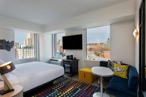 a hotel room with a bed and a large window at Aloft Providence Downtown in Providence