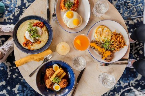 a table topped with plates of food and eggs at Aloft Providence Downtown in Providence