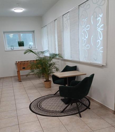 a room with a desk and chairs and a table at Ferienwohnungen Hebalm in Pack