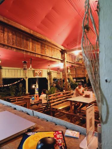 a restaurant with wooden tables and people sitting at tables at Sea Views bungalow kohrong in Koh Rong Island