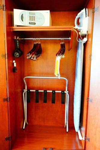 a closet with utensils hanging on a wall at Courtyard Monterrey San Jeronimo in Monterrey
