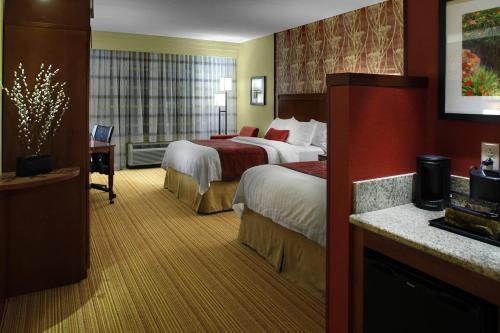 a hotel room with two beds and a desk at Courtyard by Marriott Boone in Boone