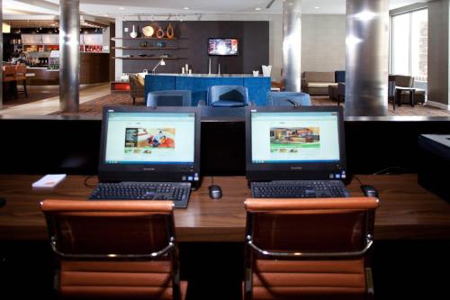 two laptops sitting on top of a wooden table at Courtyard by Marriott Boone in Boone