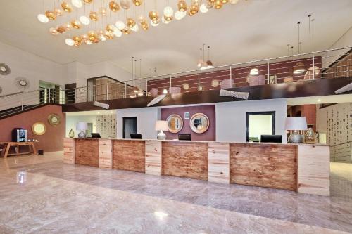a lobby with a reception desk in a building at Protea Hotel by Marriott Ndola in Ndola