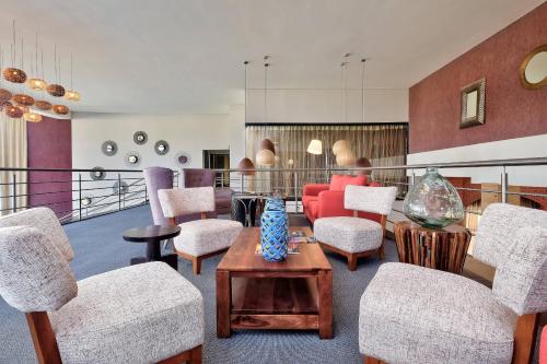 a living room with chairs and a table at Protea Hotel by Marriott Ndola in Ndola