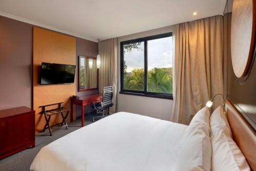 a hotel room with a large bed and a window at Protea Hotel by Marriott Ndola in Ndola