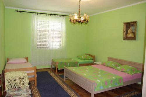 a bedroom with two beds and a chandelier at Stefanelo in Ulcinj
