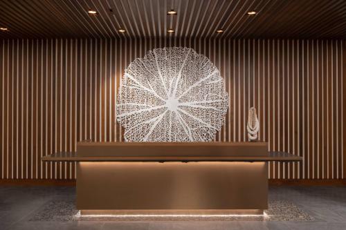 a large sculpture of a flower on a wall at AC Hotel by Marriott Maui Wailea in Wailea