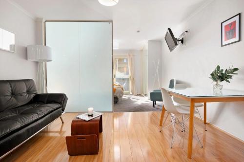 a living room with a couch and a table at Melbourne Street Haven in North Adelaide
