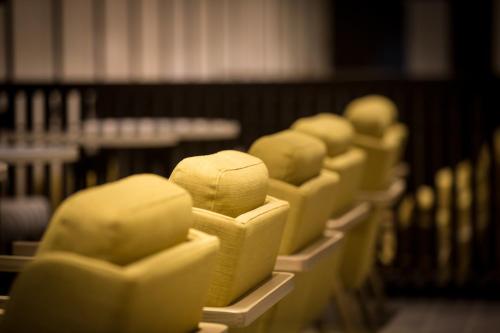 a row of yellow hats sitting on a shelf at Azalaï Hôtel Nouakchott in Nouakchott