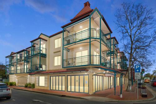 a tall building with balconies on a city street at Melbourne Street Haven in North Adelaide
