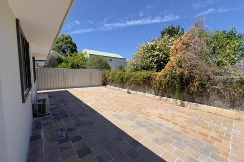 a view of a brick patio with a fence at A3 AirportRetreat - Full Kitchen, Biz & Leisure in Perth