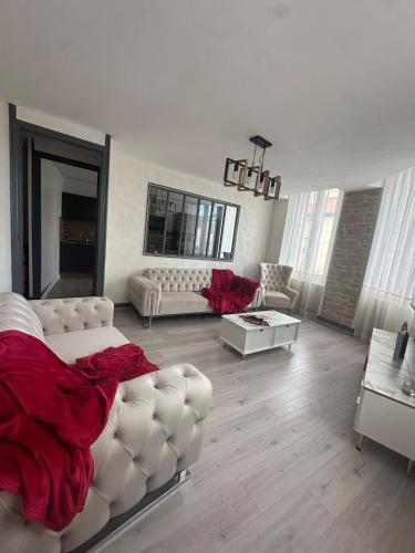 a living room with white furniture and red blanket at Tain centre -T3- wine themed apartment in Tain-lʼHermitage