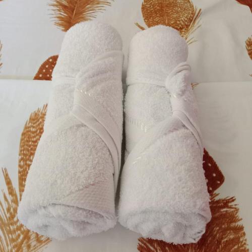 a pair of white socks sitting on a bed at Villa Fria private beach cottage in San Vicente
