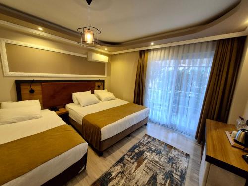 Katil atau katil-katil dalam bilik di Toprak Apart Otel