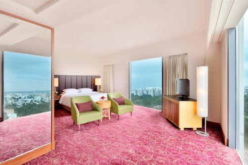 a hotel room with a bed and a large mirror at Courtyard by Marriott Hyderabad in Hyderabad