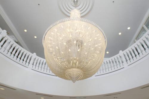 a large crystal chandelier hanging from a ceiling at Inn at Bay Harbor, Autograph Collection in Petoskey