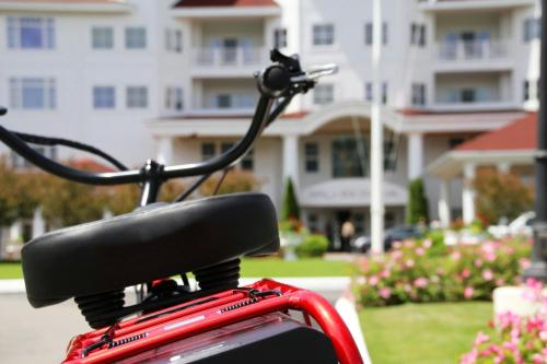 a red bike parked in front of a building at Inn at Bay Harbor, Autograph Collection in Petoskey