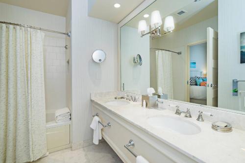a bathroom with two sinks and a large mirror at Inn at Bay Harbor, Autograph Collection in Petoskey