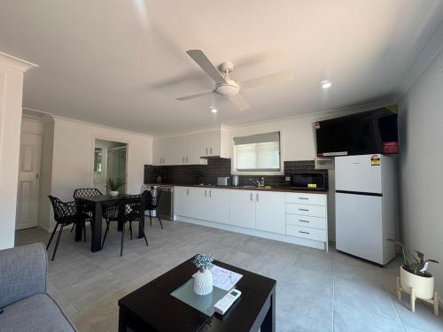 a kitchen and living room with a couch and a table at A newly renovated home and only 2 minutes to Highway - modern and handy in Raymond Terrace
