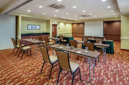 a conference room with tables and chairs and a podium at Courtyard by Marriott Jacksonville Beach Oceanfront in Jacksonville Beach