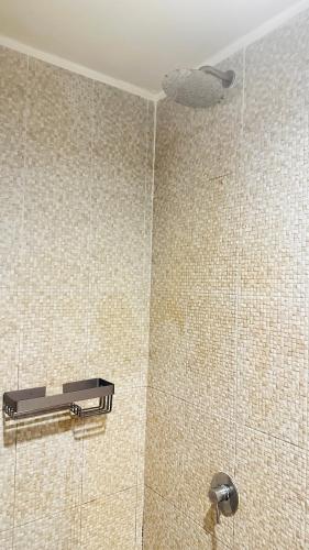 a shower with a shower head in a bathroom at Green Residence Hotel in Bang Rak Beach