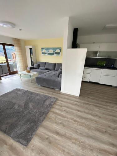 a large living room with a couch and a table at Gästehaus und Ferienwohnung Bächle in Bad Peterstal